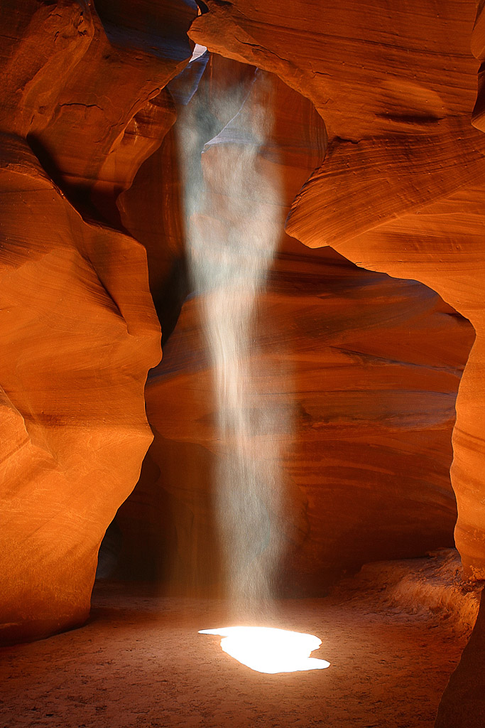 The once-been-secret Antelope Canyon is today bustling with photographers and tourist form all over the world. Nonetheless you still can catch the beauty and majestic of this place with a little preparation. This shot was made in a group of about 6 photographers lining up in front of this subject, pointing out one of the group every time to run 200 meters out to get dry sand and throw it in the beam from behind the edge to let the others photograph this phantastic view.